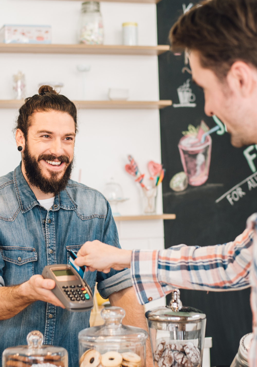 business owner accepting a credit card payment from a customer in person